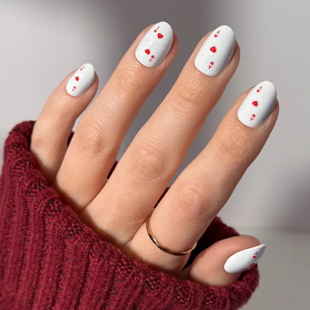 Ace of Hearts press-on nails in red heart design with glossy finish stylish nail set on hand close-up