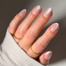 Angelic Touch press-on nails in soft pastel pink with delicate love notes design nail set on natural nail shape