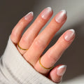 Angelic Touch press-on nails in soft pastel pink with delicate love notes design nail set on natural nail shape
