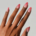 Faded Feelings press-on nails in soft faded pink shades with almond shape stylish nail set on hand close-up