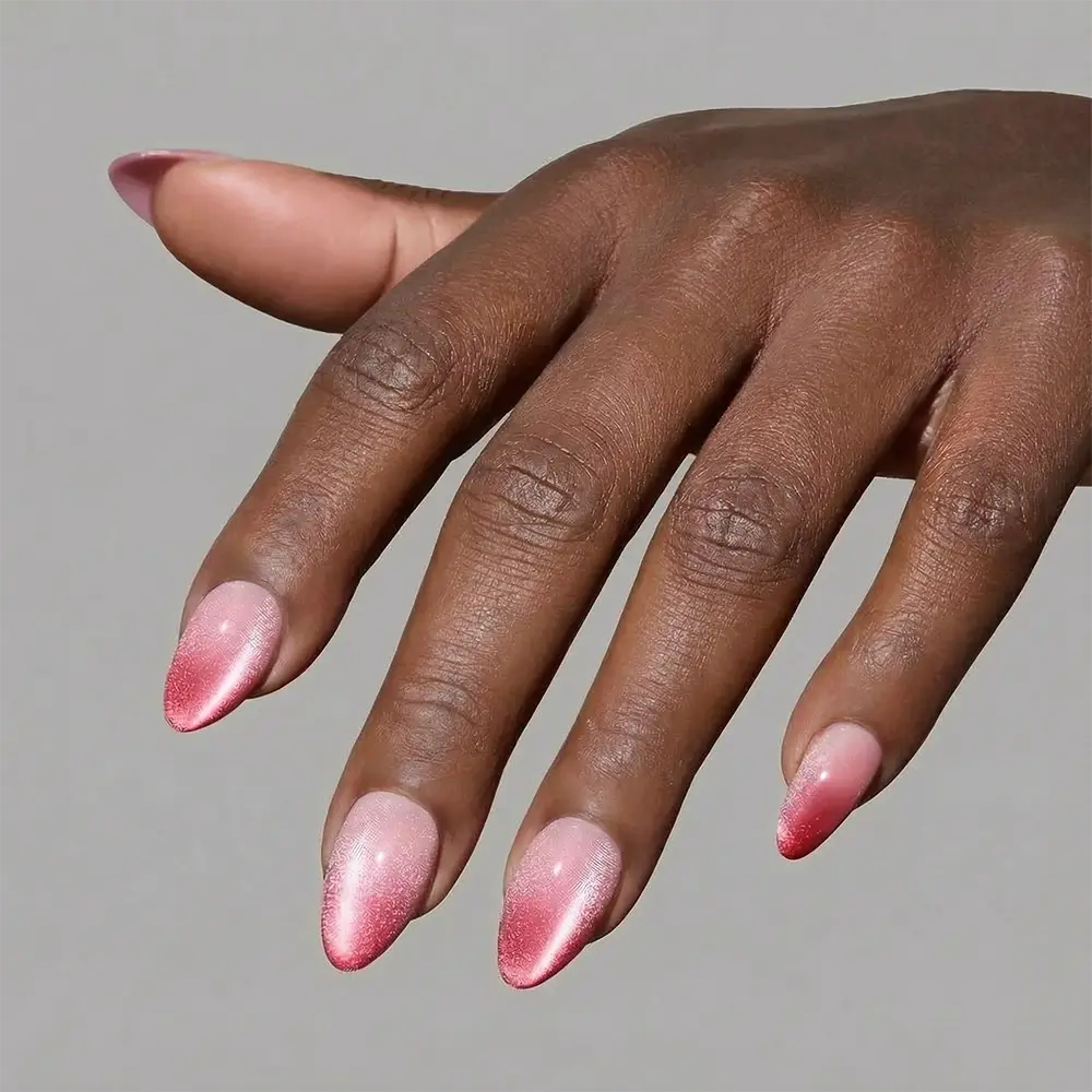 Faded Feelings press-on nails in soft gradient colors styled in almond shape elegant nail set on hand close-up