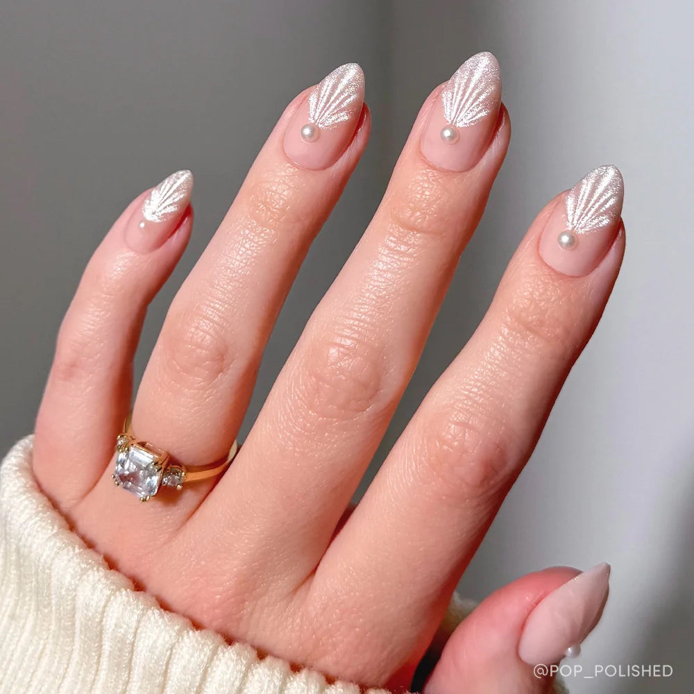 Honeymoon press-on nails set featuring elegant soft pink almond-shaped nails for a romantic look