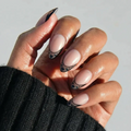Love Noir press-on nails in glossy deep black color with almond shape stylish nail set on natural hands