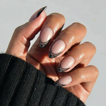 Love Noir press-on nails in glossy deep black color with almond shape stylish nail set on natural hands