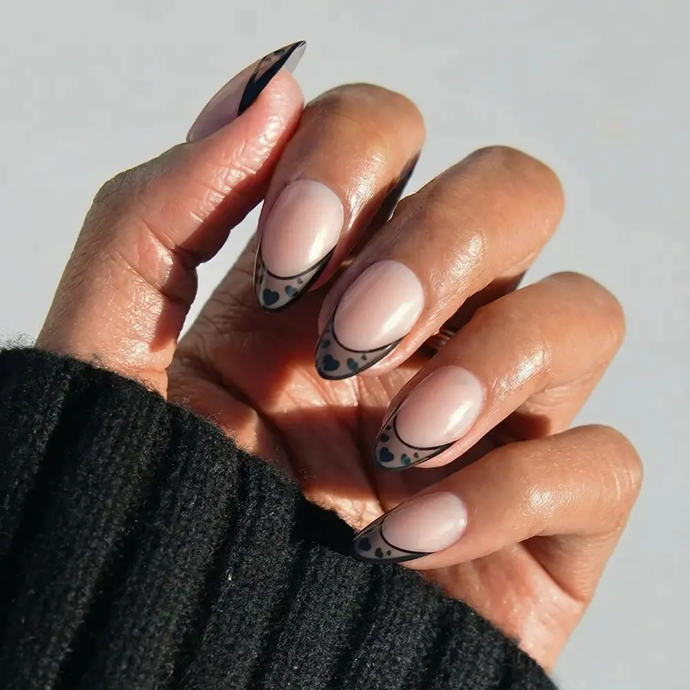 Love Noir press-on nails in glossy deep black color with almond shape stylish nail set on natural hands