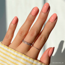 Peach coral press-on nails with glossy finish showcasing vibrant peach and coral shades on natural nail shape