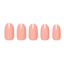 Peach coral press-on nails featuring glossy finish and rounded shape perfect for summer nail looks