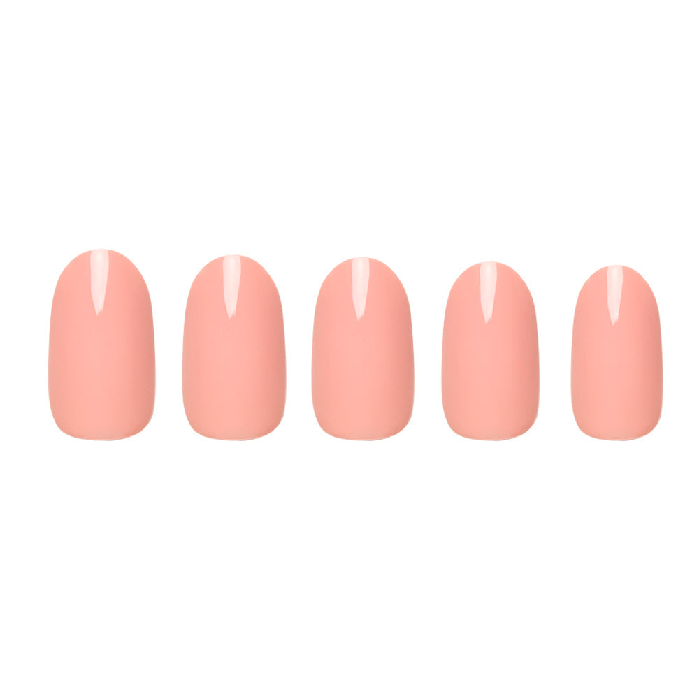 Peach coral press-on nails featuring glossy finish and rounded shape perfect for summer nail looks