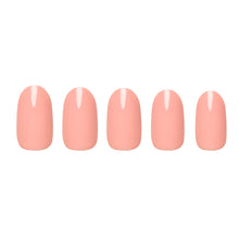 Peach coral press-on nails featuring glossy finish and rounded shape perfect for summer nail looks