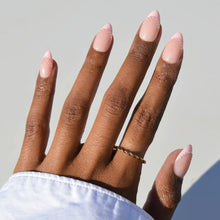 Pink Me Up press-on nails featuring soft pink almond-shaped nails in a stylish nail set with a glossy finish