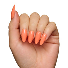 Soft Tangerine press-on nails in a soft orange shade showcasing a natural oval shape nail set