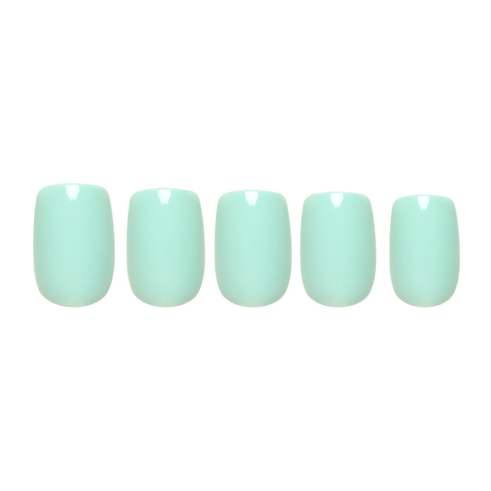 Soft teal press-on nails in a smooth matte finish showcasing elegant oval shape nail set display